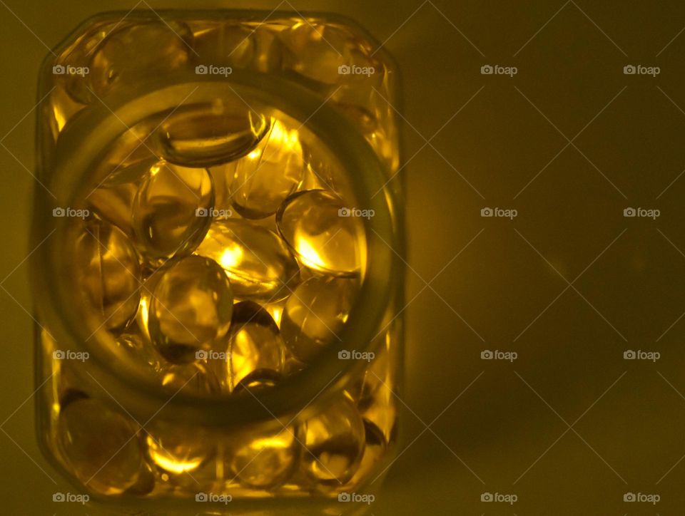 golden yellowish transparent balls in a container