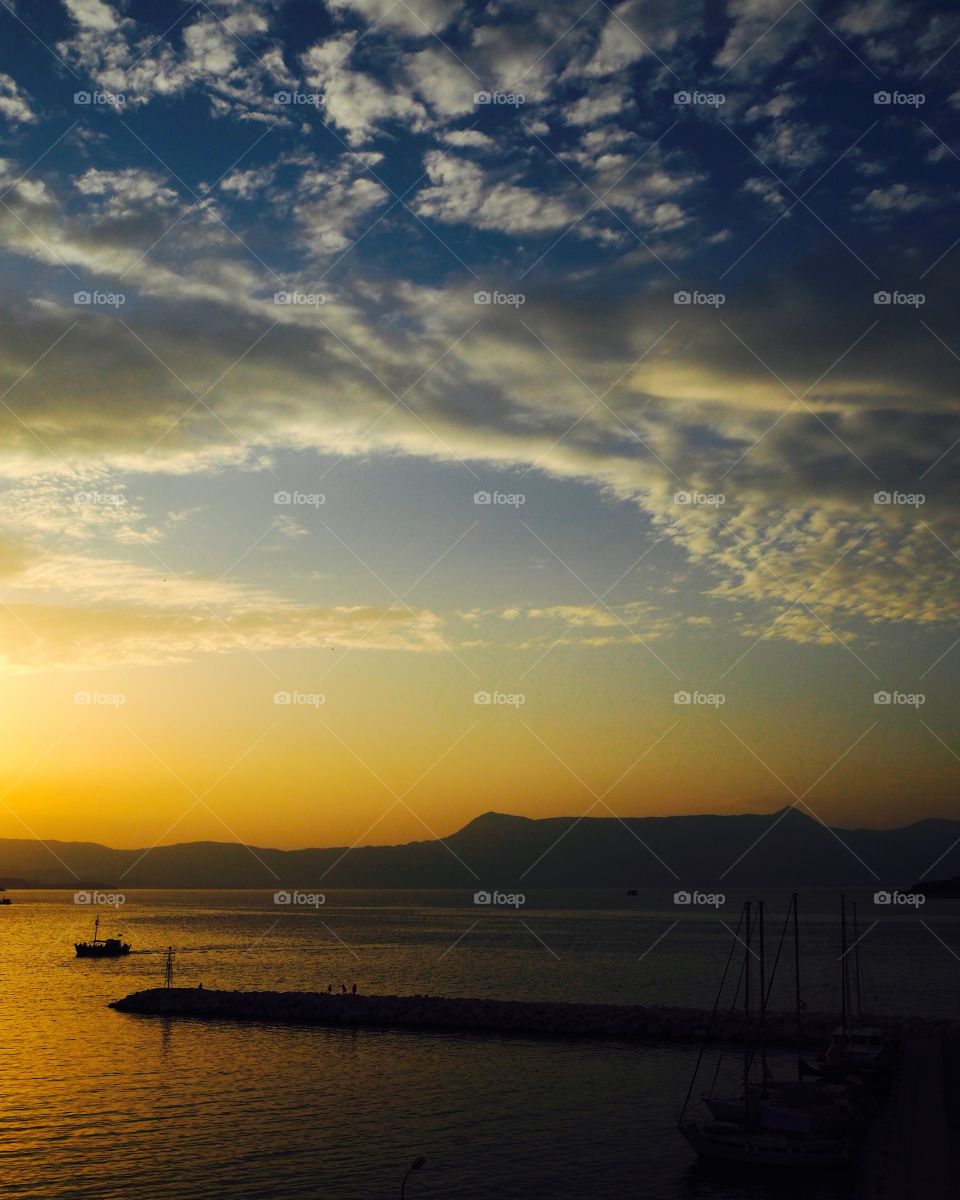 Deep sunset over Corfu Town Old Harbour, Greece