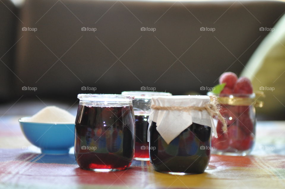 Homemade cherry jam on table