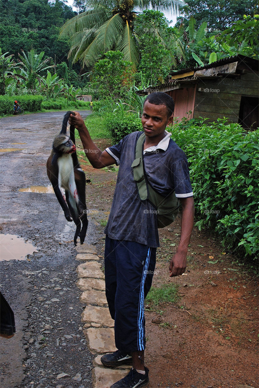 São Tomé boy with bushmeat. 