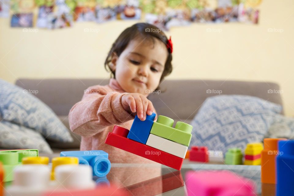 my little girl playing with building blocks