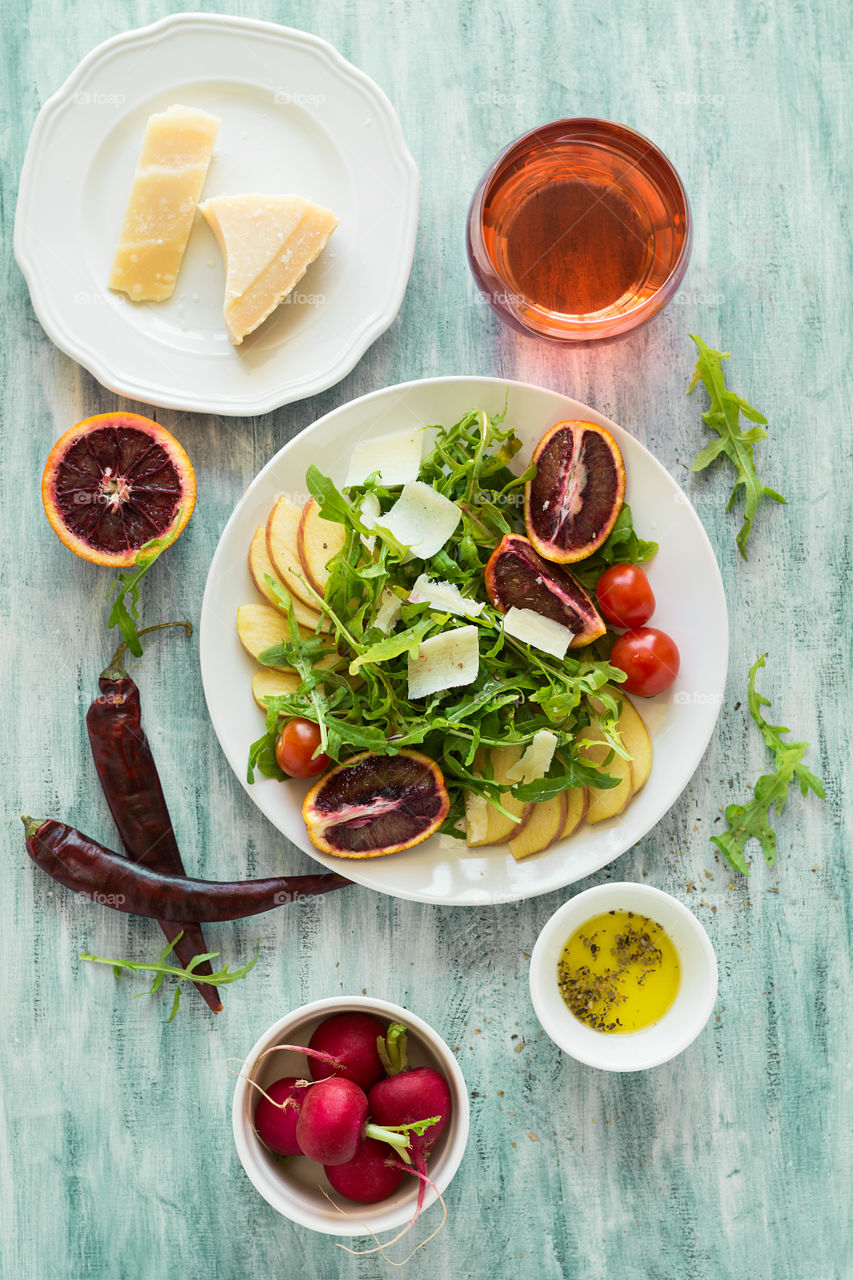 Fresh salad with arugula, pear, blood orange, tomatoes and parmesan