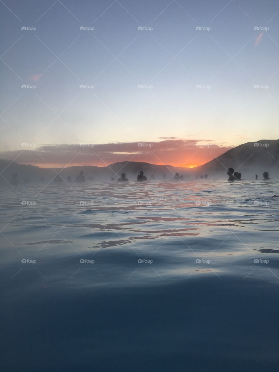 View of a blue lagoon with people in Iceland