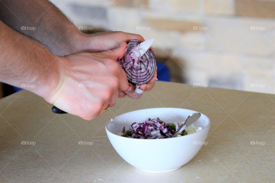 Close-up of person cutting onion