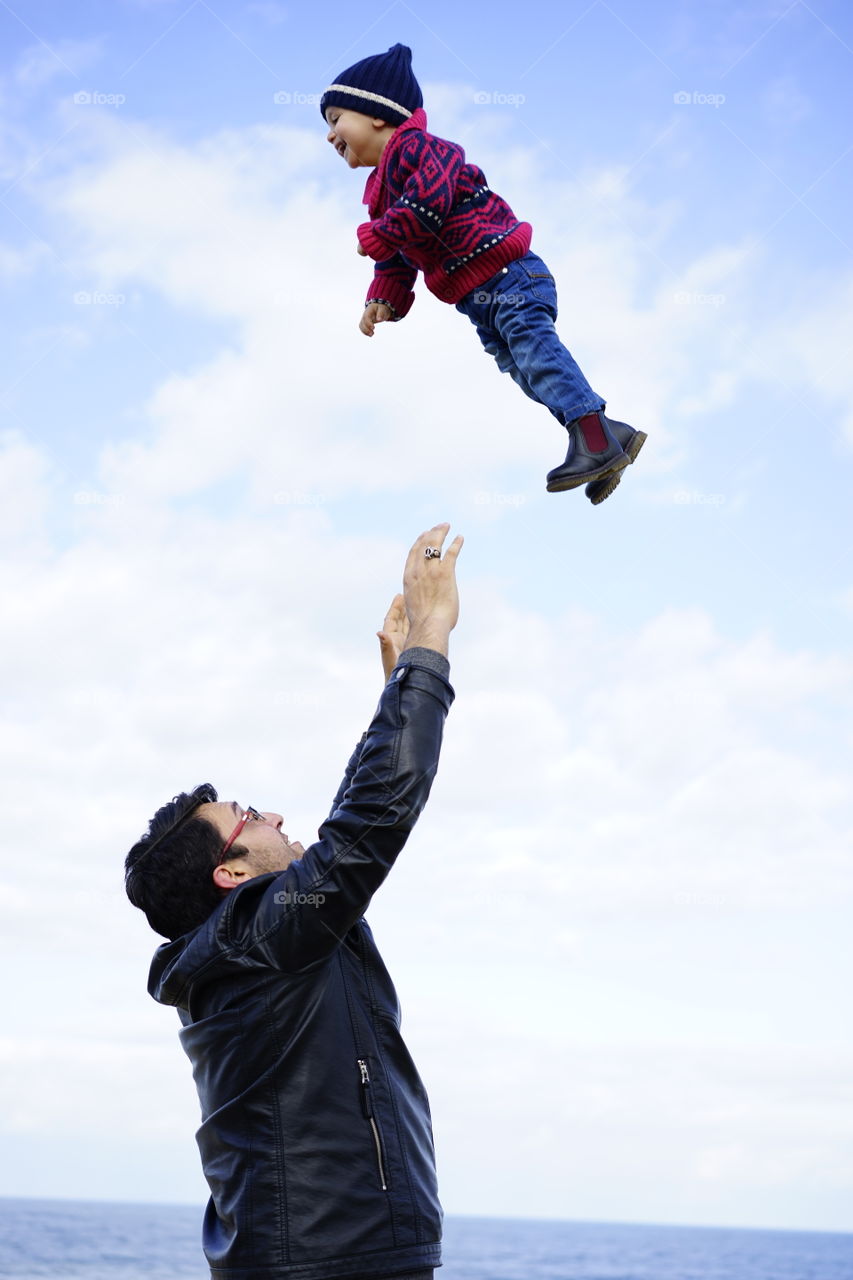 Father throwing his son