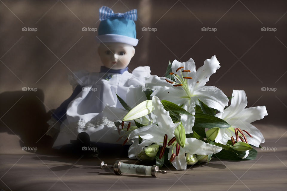 old doll, lilies, cannula