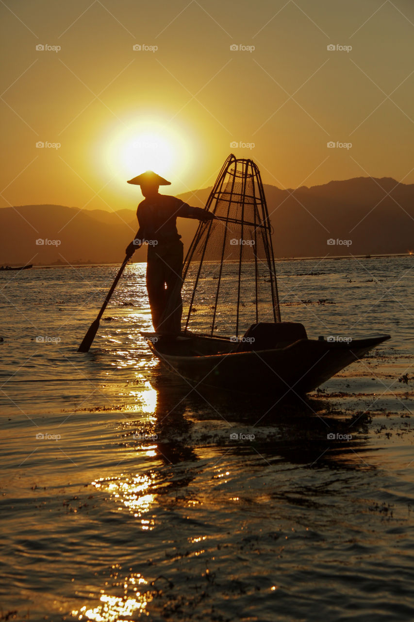 Fisherman heading home at sunset 