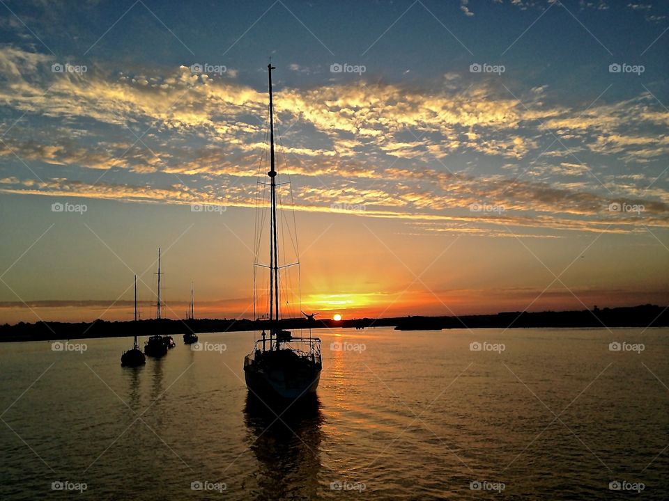 sailboat silhouettes on a sunset in Portugal