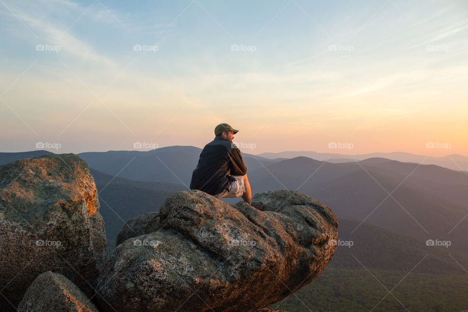 A hiker summits Old Rag, VA at dawn