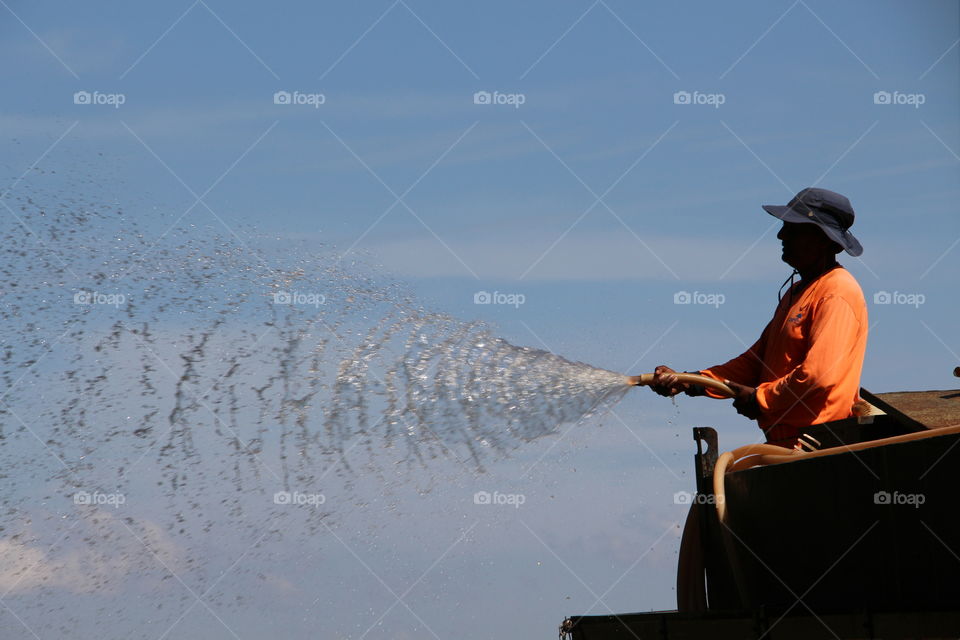 Landscape Worker Waters Plants