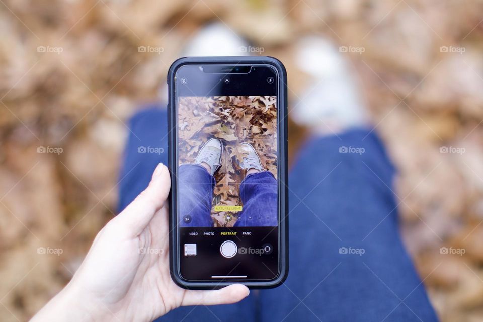 Enjoying the fall leaves and making sure to capture the moment with Apple