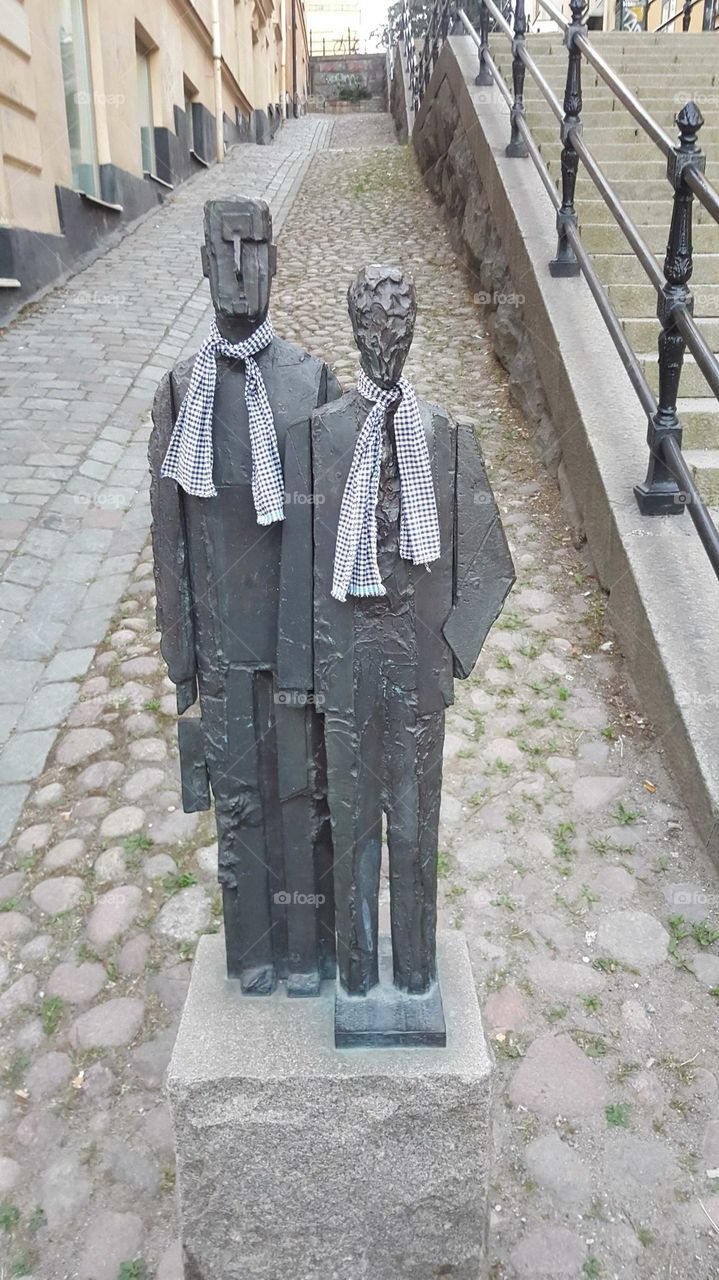 Grey men veiled in grey scarves