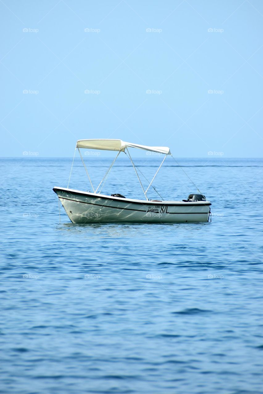 A boat on the blue sea water