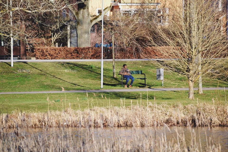 A man sitting on a bench in the park