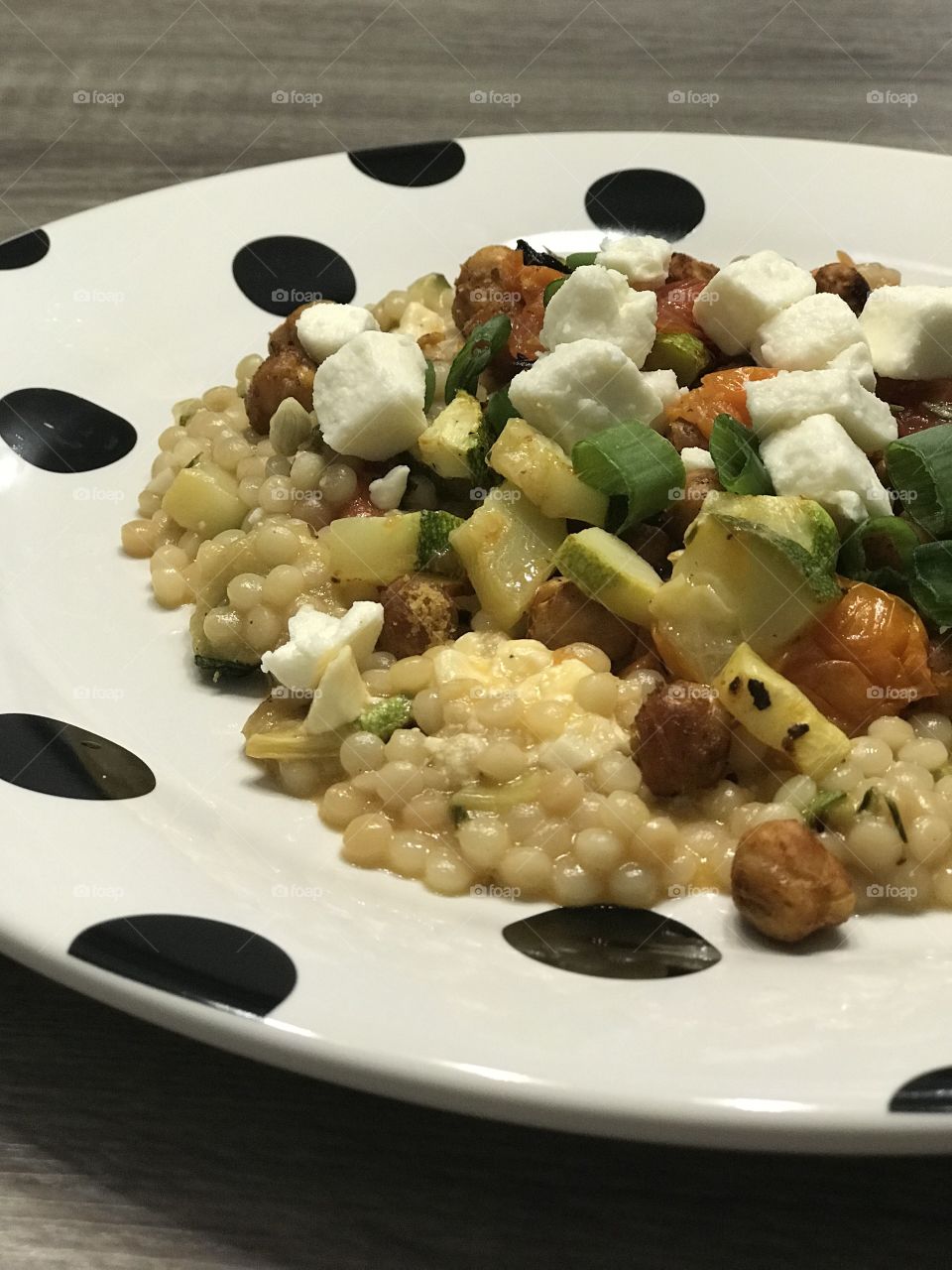 Close up of couscous dish with vegetables plated for dinner