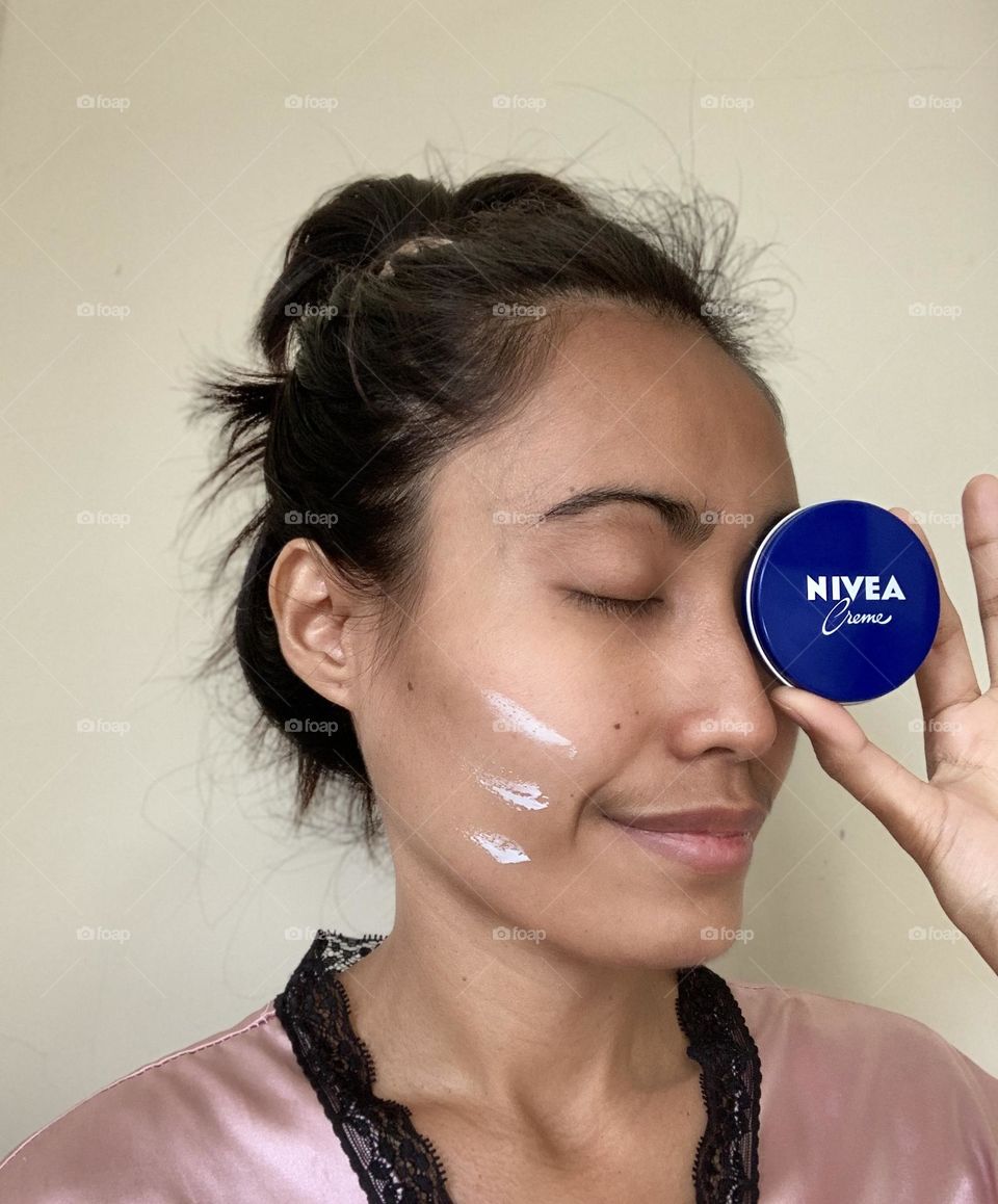 Nivea creme used by a lady.