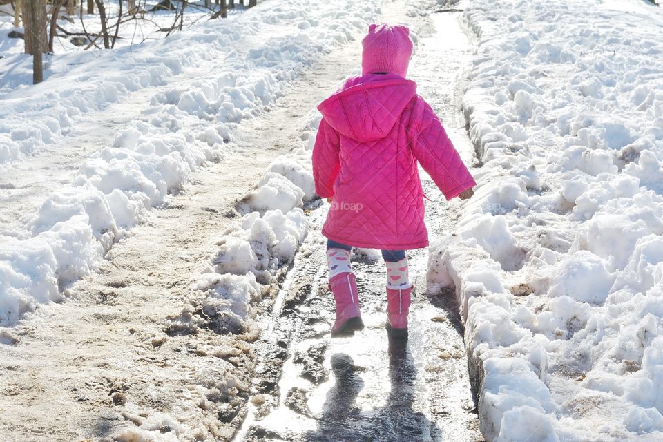 Little girl wearing pink in the snow