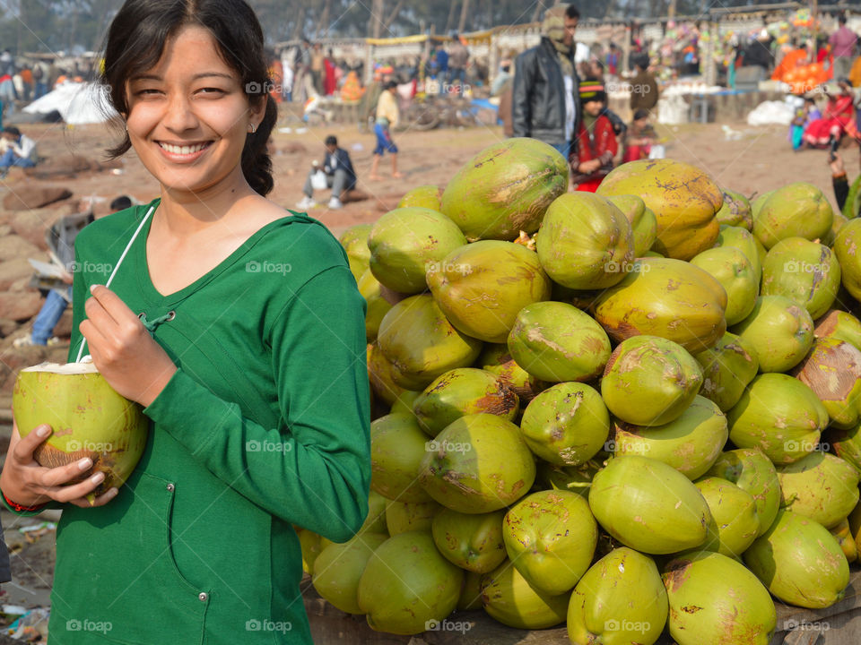 Young woman drinking coconut water