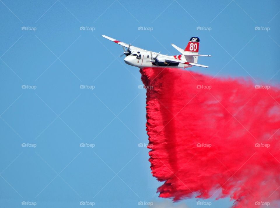 Firefighting Aircraft. California Department Of Forestry Firefighting Aircraft Dropping Retardant On A Forest Fire
