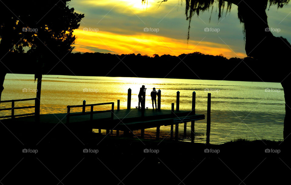 Viewing the viewers. People standing on a dock admiring an aw semi golden hour!