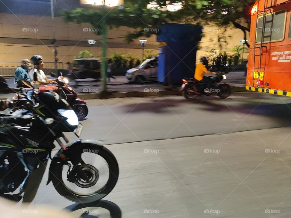 Two riders on a sleek motorcycle, wind in their hair, zooming down the open road with exhilaration, embodying freedom and adventure.