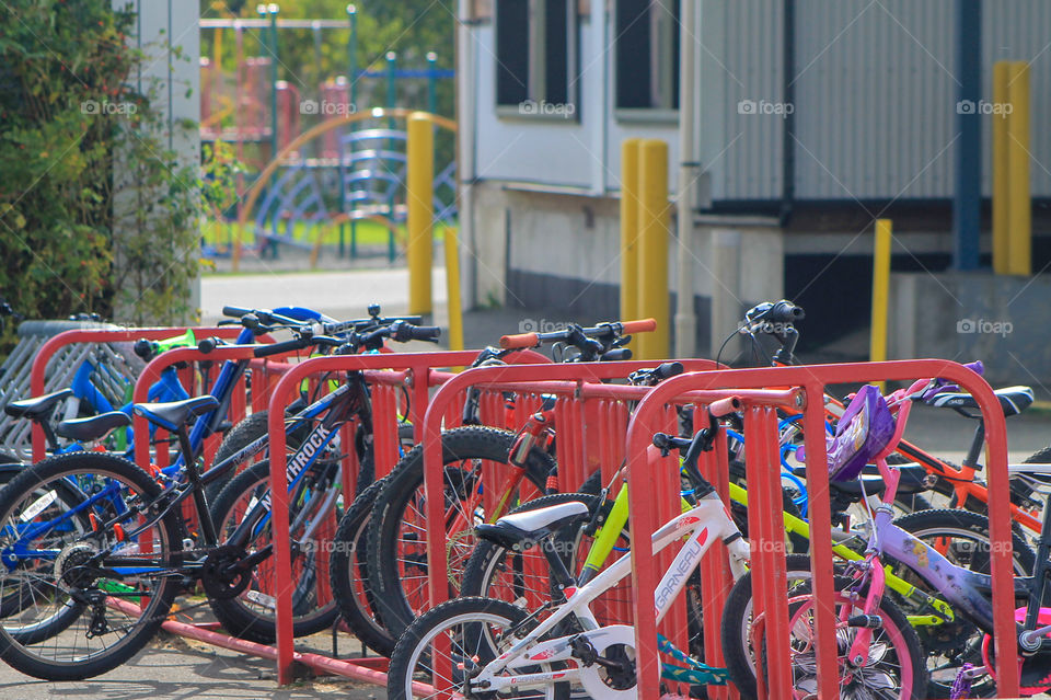 Point A to B. Weather is quite mild & many people bike all year round. For students who live relatively close to their schools biking is extremely popular transportation. At this school,  the red bike rack is completely filled with students bikes. 🚲