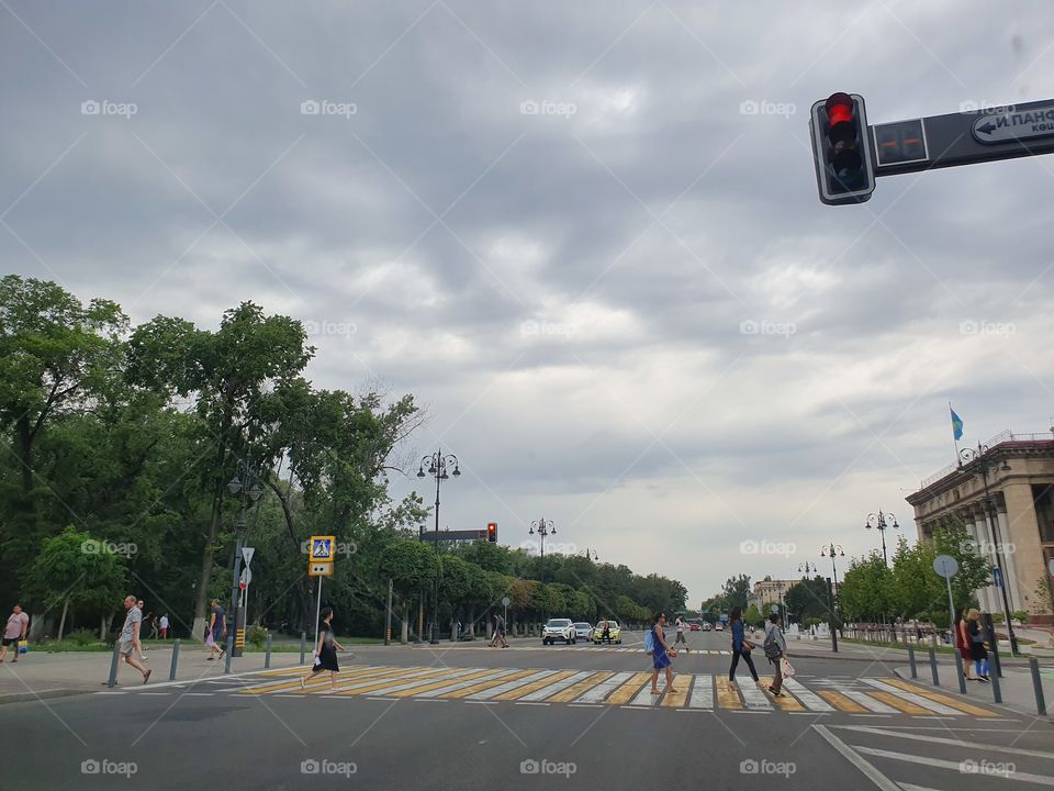 city view with traffic lights and cloudy sky