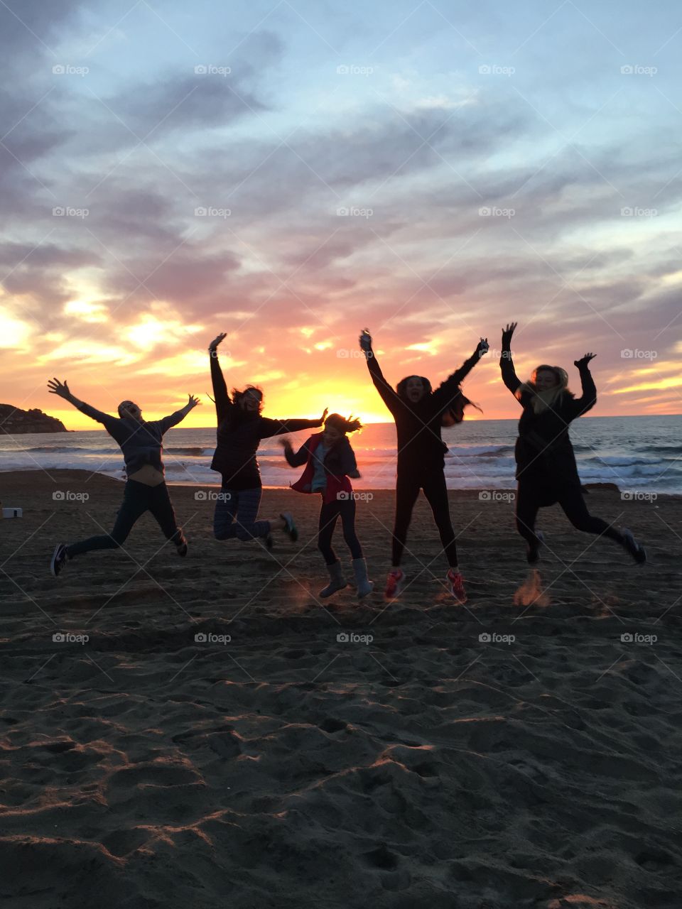 Sunset family jumping silhouette 