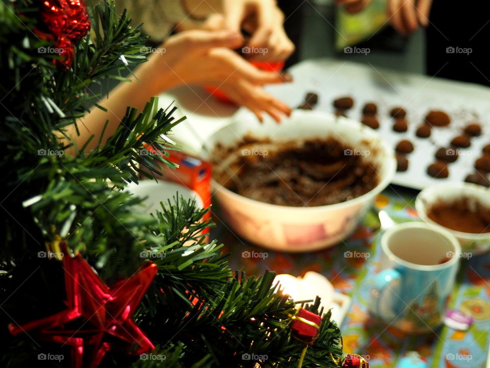 baking Christmas sweets with chocolate, in the front is a Christmas tree