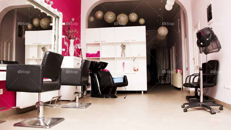 beauty salon. hair dresser chairs and mirror in beautiful decorated salon