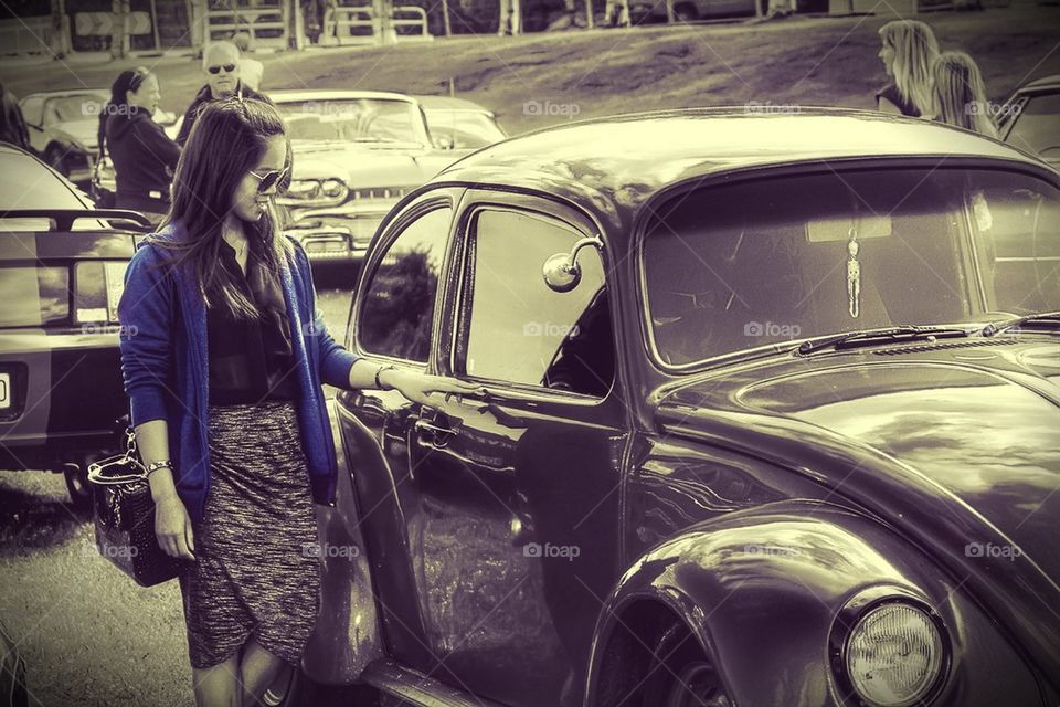 Girl admiring a retro Beetle