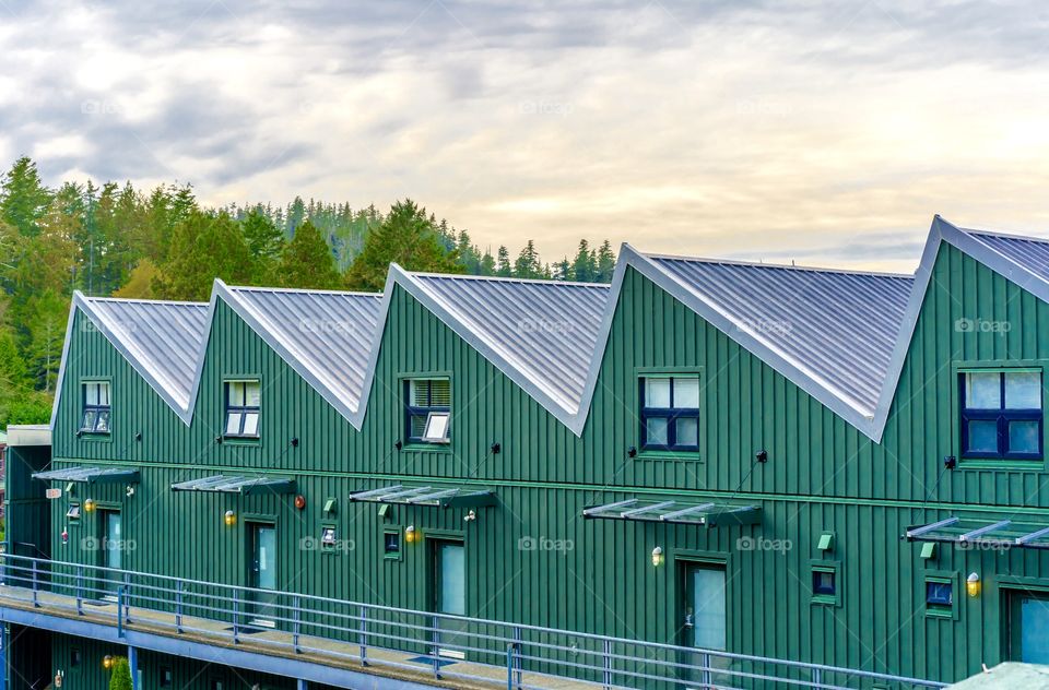 Zigzagging roof with lined green building and colourful sky - Tofino, Vancouver Island, British Columbia, Canada 