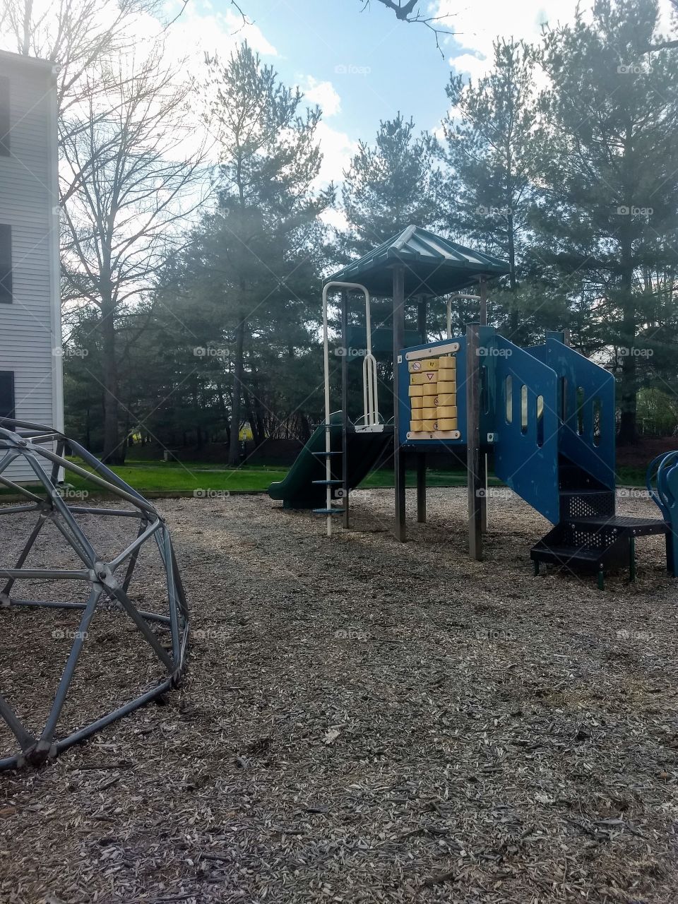 playground next to trees and apartment building