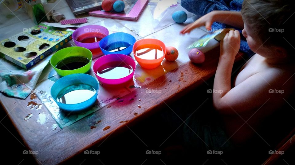 Boy dying Easter Eggs. It's almost Easter and this little boy is dying his eggs for Easter.
