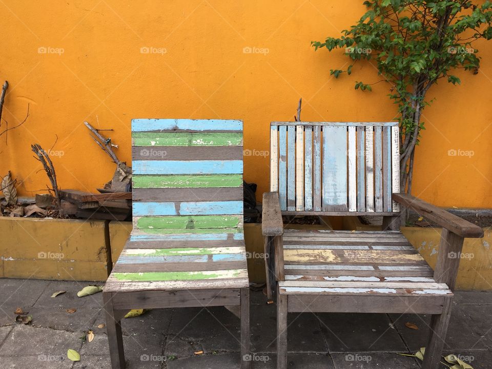 Vintage chairs, orange wall background 