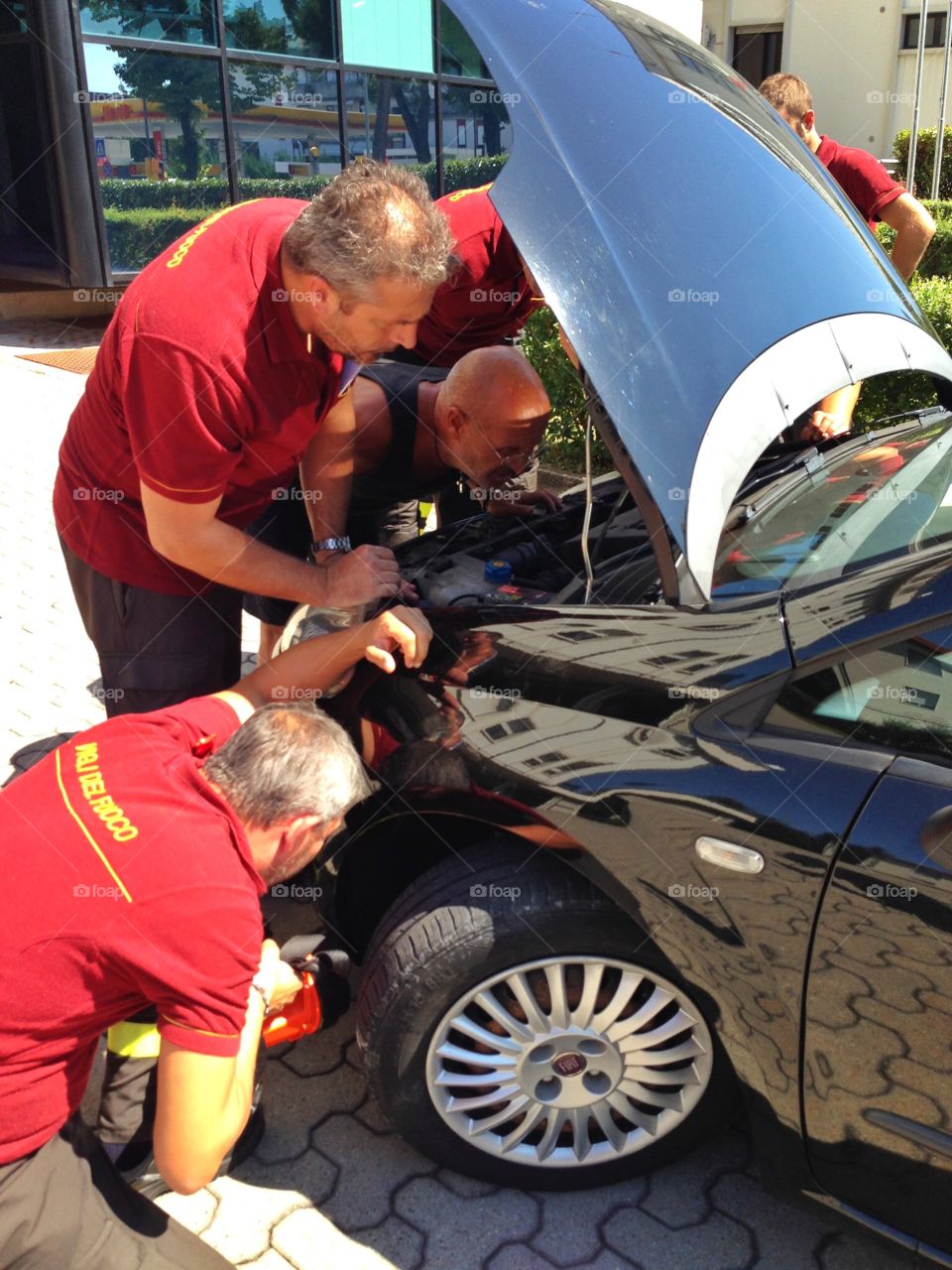 Firefighter at work. Firefighter at work across the car