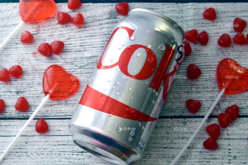 A can of diet Coke with candy hearts only white rustic that