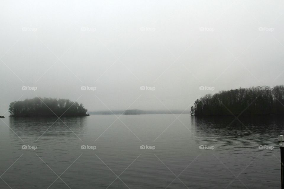 fog settling on lake around islands.