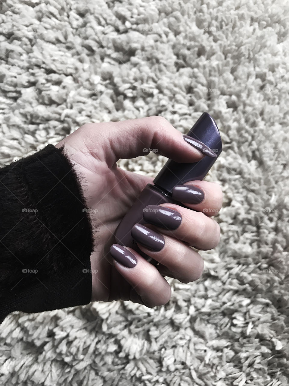 Purple nail polish in hand 