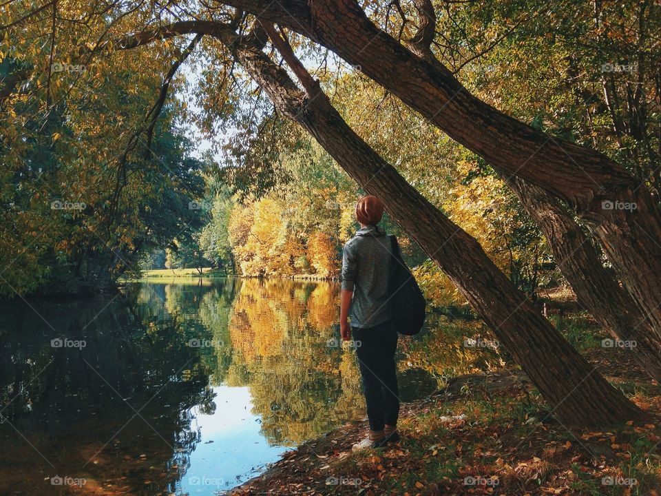 A person standing near lake