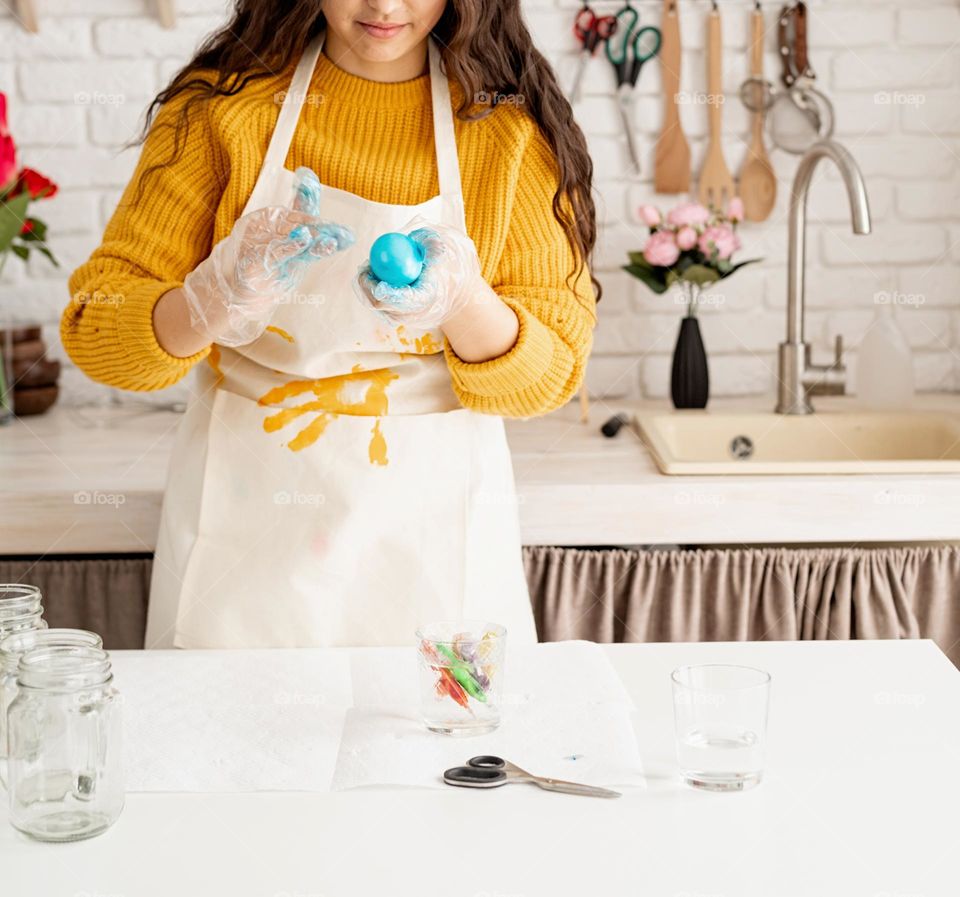 Easter scene woman coloring eggs at home