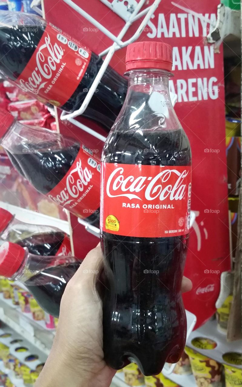 Coca-Cola bottle in hand...