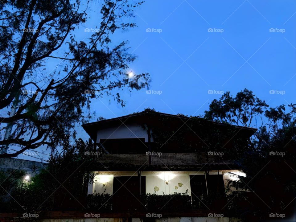 Silhouette of a house with illuminated windows