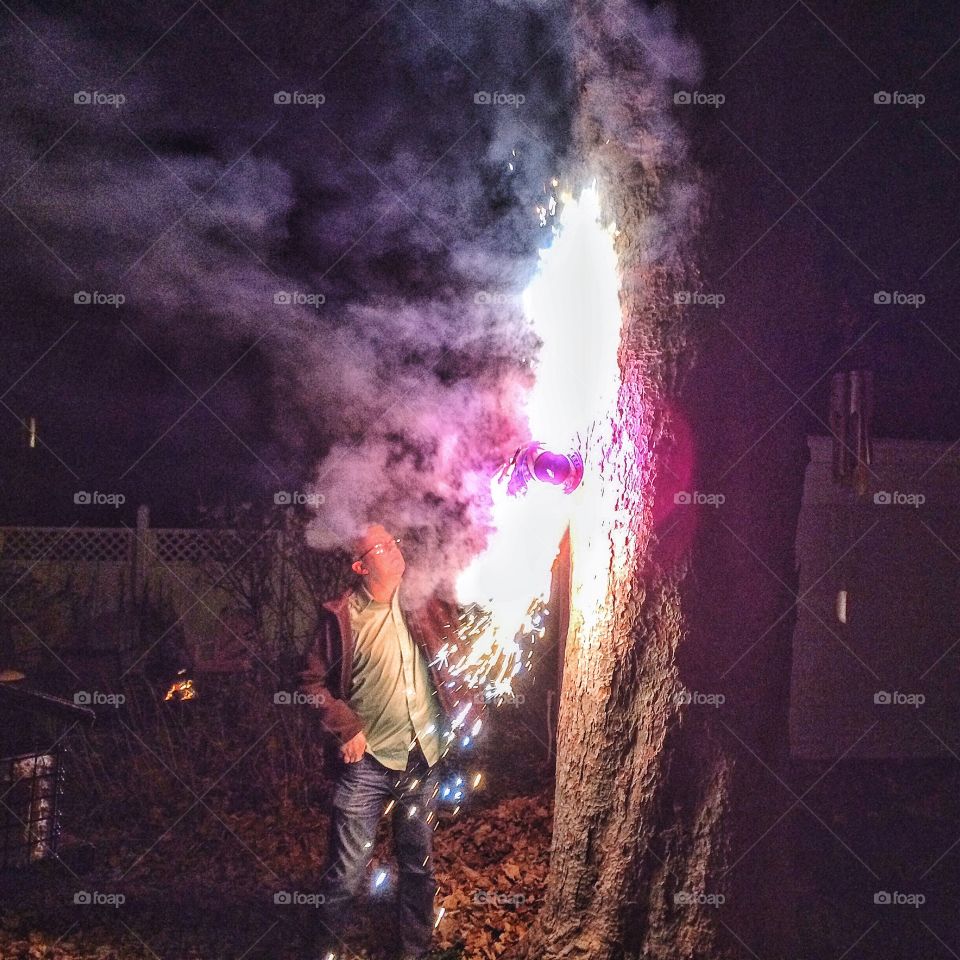 Senior man cutting trees