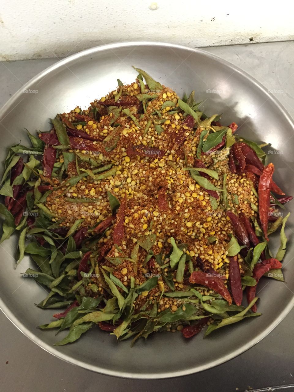 Curry leaves, lentils, and chilli peppers