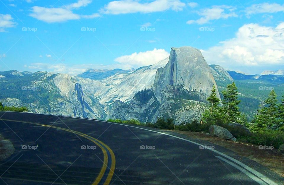 No guardrails! Sharp curve in Yosemite National Forest highway through Glacier Point, California, sudden drop, heights