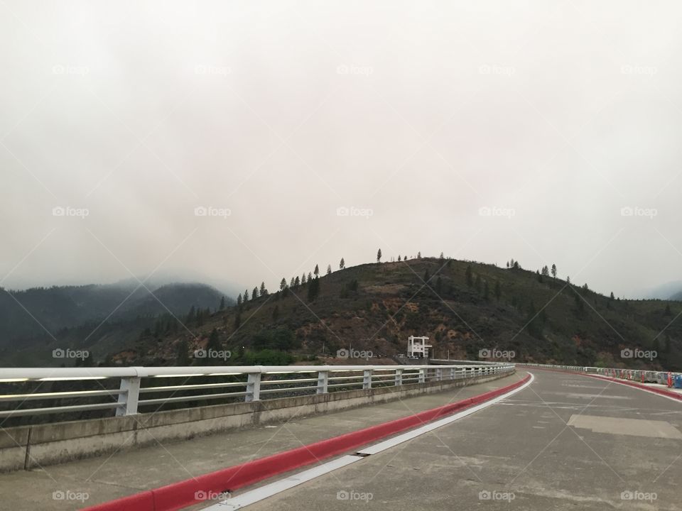 Shasta dam. Smoke from fires crawling  over mountains at end of our walk