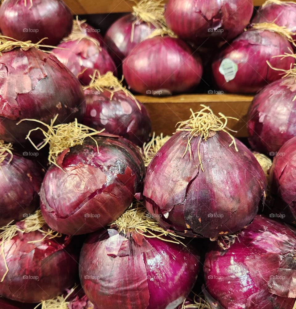 close up of red purple onion produce stack for sale in an Oregon market