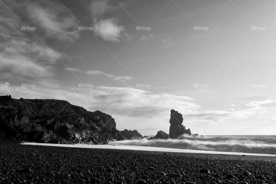 Djupalonssandur black beach in Snaefellsnes peninsula in Western Iceland in black and white long exposure on October evening.