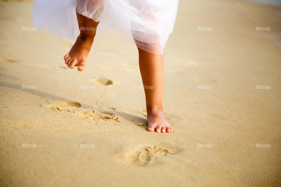 Legs on sandy beach 